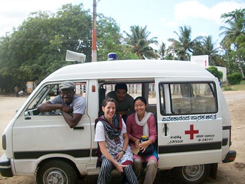Jennifer with locals and white van