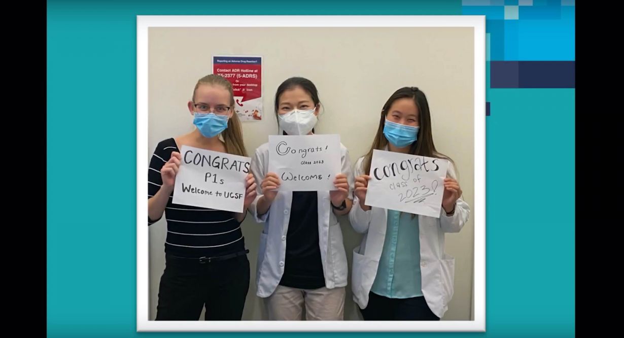 Masked students hold signs that read "Congrats Class of 2023."