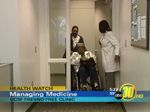 a patient in a wheelchair is pushed by another person while a health care provider holds a door open