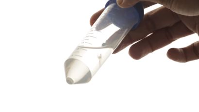 a hand holds a pointed graduated cylinder.