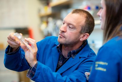Gartner holding a petri dish