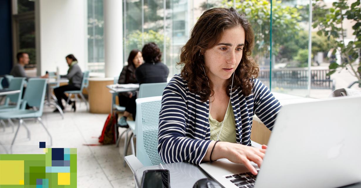 student working on laptop in cafe