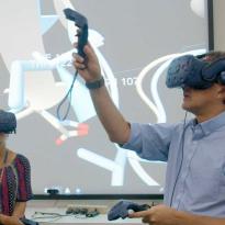 Winger and Jacobson wearing VR gear