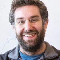 Elisabeth Fall Fraser stands in front of a whiteboard