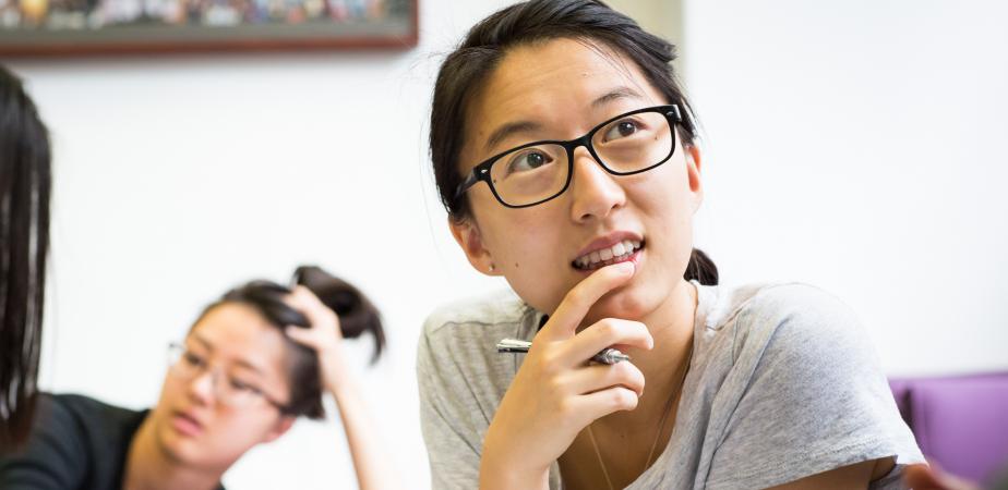 Student listening thoughtfully in seminar room