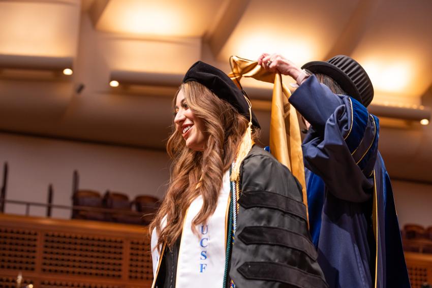 student gets hooded by Giacomini