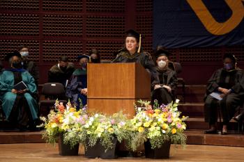 Leal speaks from a podium.