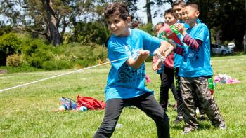boy pulls on rope