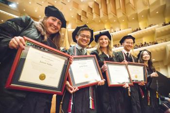 five nominees holding plaques.