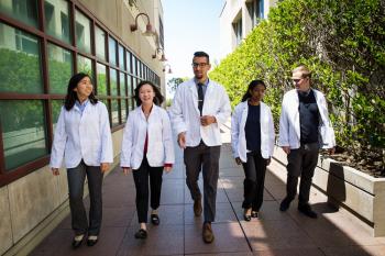 students walking in white coats