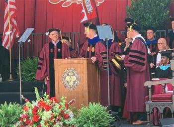 Wells on stage in regalia.