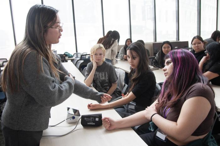Pharmacy student demonstrates how to take blood pressure readings.