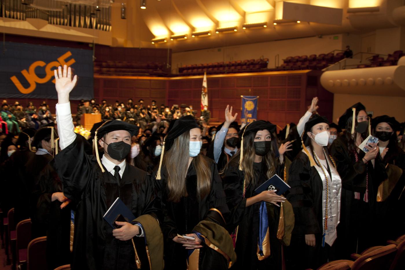 Students wave to the audience