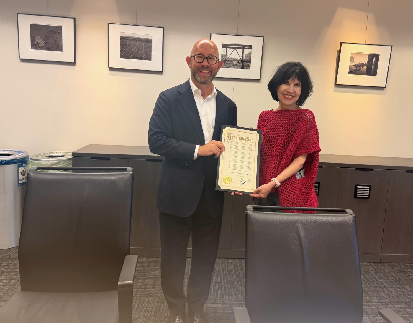 Rafael Mandelman presents Giacomini with a proclamation